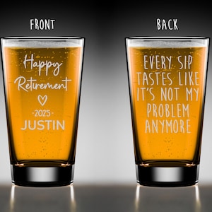 May include: A clear pint glass filled with a golden liquid, likely beer, with the words "Happy Retirement" and "Justin - 2025" etched on the front. The back of the glass reads "Every sip tastes like it's not my problem anymore."