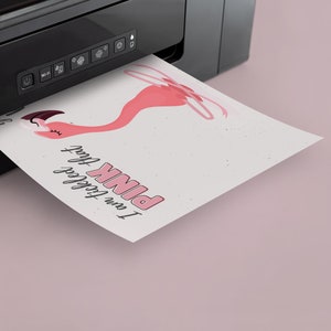 May include: A pink flamingo illustration with the text "I am totally obsessed with PINK" printed on a white sheet of paper coming out of a black printer.