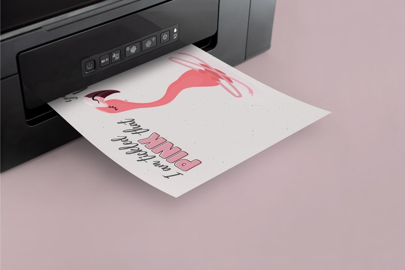May include: A pink flamingo illustration with the text "I am totally obsessed with PINK" printed on a white sheet of paper coming out of a black printer.