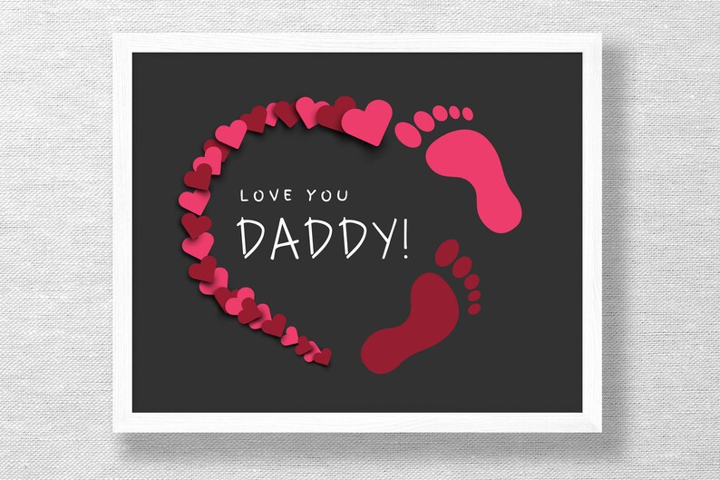 May include: A black and white printable art print with a pink and red heart shape made of small hearts and two red footprints. The text "Love you Daddy!" is written in white inside the heart.