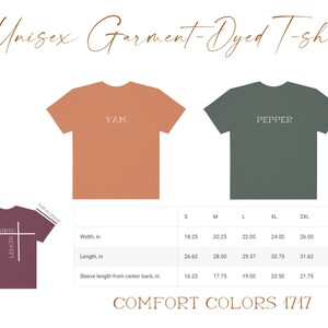 May include: Unisex garment-dyed t-shirt in two colors: a peachy orange with the word "YAM" printed on it and a dark green with the word "PEPPER" printed on it. A size chart is included with measurements in inches for width, length, and sleeve length from center back.