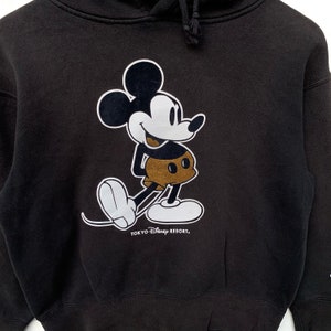 May include: Black hooded sweatshirt with a white Mickey Mouse graphic and the text "Tokyo Disney Resort."