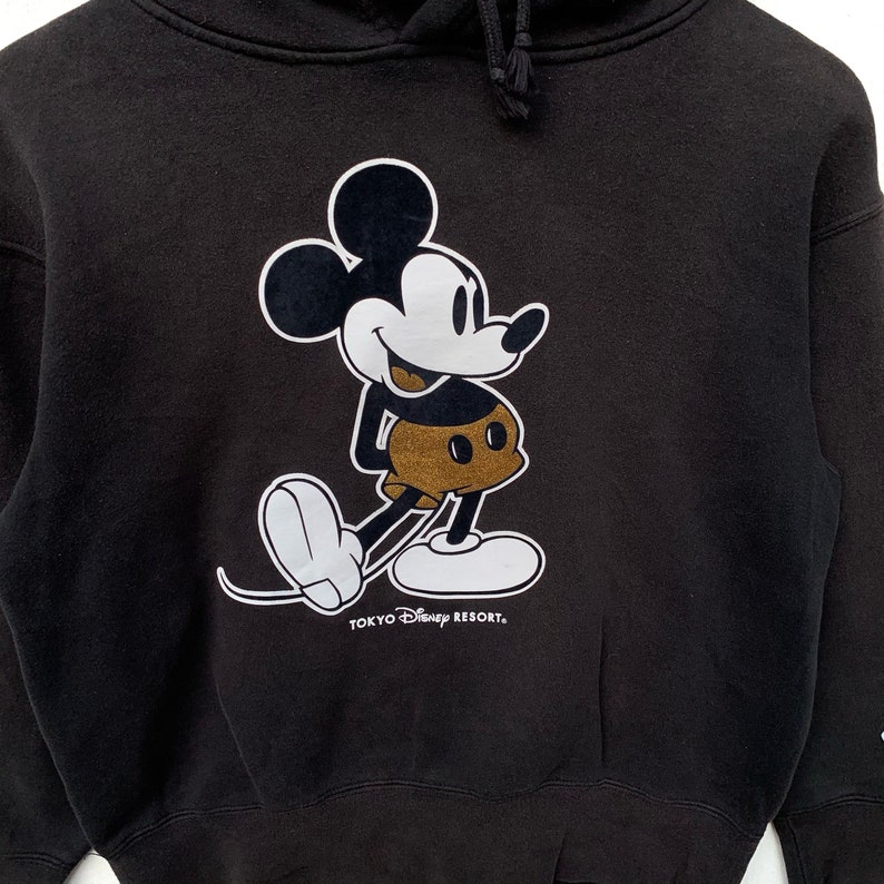 May include: Black hooded sweatshirt with a white Mickey Mouse graphic and the text "Tokyo Disney Resort."