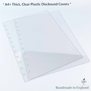 May include: Two clear plastic A4+ discbound covers. The covers are thick and have a smooth, glossy finish.