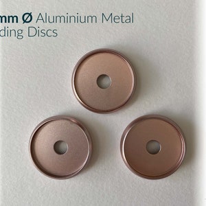 May include: Three 24mm rose gold aluminium metal binding discs.
