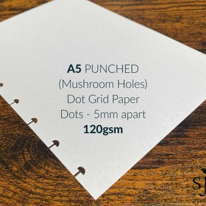 May include: A5 dot grid paper notebook with punched holes. The paper is 120gsm and the dots are 5mm apart. The notebook is white with a subtle speckled texture.