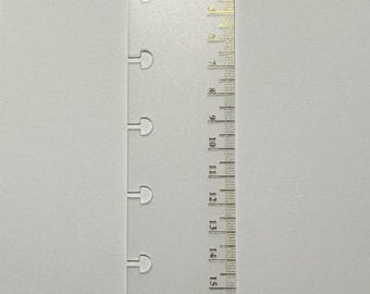May include: A translucent, frosted plastic planner bookmark and ruler featuring the word TODAY in gold foil at the top. The left edge has eight mushroom-shaped punch holes for binding, and the right edge displays a metric scale from 0 to 20 cm.
