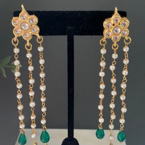 May include: Gold earrings with a floral design and white pearl and green gemstone accents.