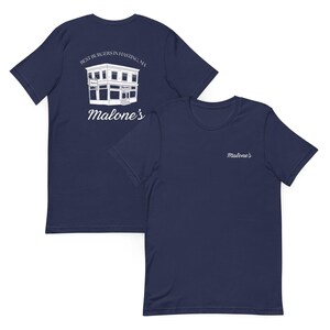 May include: Two navy blue t-shirts. One features a white illustration of a building with the text "BEST BURGERS IN HASTING, MA" and "Malone's". The other shirt has "Malone's" embroidered on the chest.