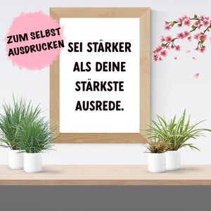 Könnte beinhalten: Ein gerahmtes Motivationszitat in schwarzer Schrift auf weißem Hintergrund lautet: "Zum Selbst Ausdrucken Sei Stärker Als Deine Stärkste Ausrede."