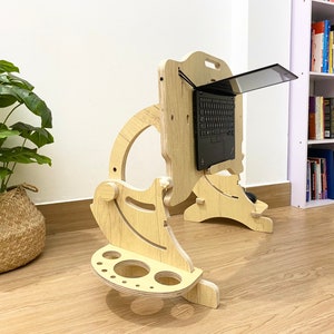 May include: A wooden laptop stand with a built-in mouse pad and cup holder. The stand is designed to elevate a laptop to a comfortable viewing height.