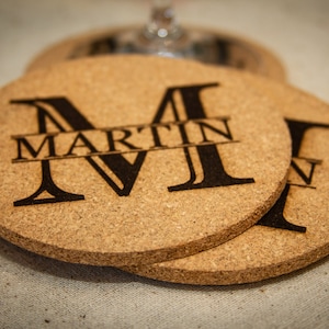 May include: Set of three cork coasters with a personalized initial and name. The coasters feature a large "M" with the name "MARTIN" printed below it.