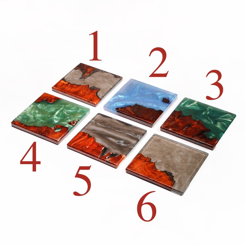 May include: Six square coasters with a wood and resin design. The coasters feature a variety of colors, including gray, blue, and green, with a natural wood grain. Each coaster is approximately 4 inches square.