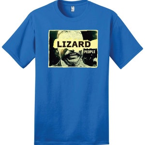 May include: A royal blue t-shirt with a graphic of a man's face with a yellow banner across his eyes that reads "LIZARD PEOPLE".