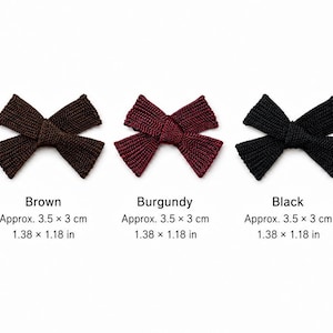 May include: Five ribbed fabric bows in red, brown, burgundy, black, and white. The red, brown, burgundy, and black bows measure 1.38 x 1.18 inches, while the white bow measures 0.98 x 0.94 inches. Each bow features a central knot detail.