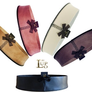 May include: Five leather-wrapped gift boxes in various colors, including brown, pink, white, purple, and black. Each box has a small bow and a gold label with the text "BY LUP 20 95-714 05-7 80 SMT-20 05-714 56 05-7 95".