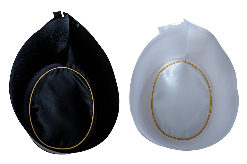 May include: Two hats, one black and one white, each featuring a rounded crown with a gold-colored trim border. The hats have a distinct, tall, pointed back section and a smooth, satin-like finish on the top surface, presented against a white background.