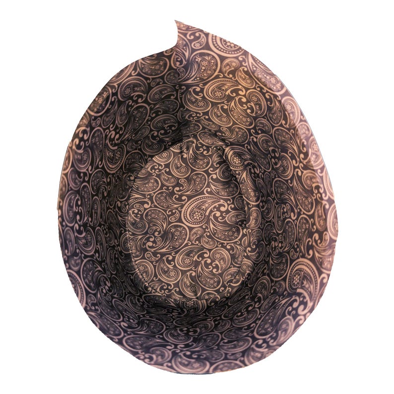 May include: A black and white paisley patterned fabric bowl. The bowl is empty and the fabric is folded over the top edge.