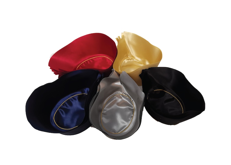 May include: A collection of five satin tricorn hats arranged in a circular pattern. The hats are available in red, gold, navy blue, silver, and black. Each hat features a smooth, shiny finish and a contrasting gold-colored trim along the inner brim.