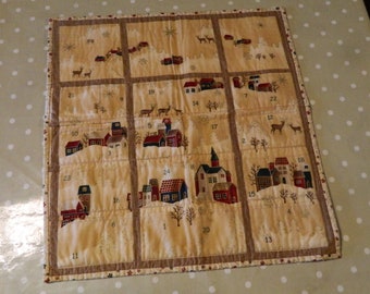 fabric advent calendar with pockets, a sleeve on the back for hanging up. advent calendar for adults, 100% cotton fabric and quilted,
