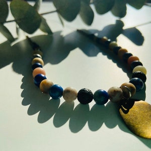 Earth coloured beaded wire necklace with bronze pendant