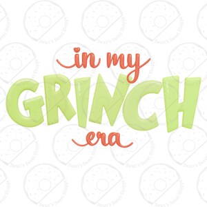 May include: A graphic design with the text "in my GRINCH era" in a playful font. The word "GRINCH" is in a bright green, while "in my" and "era" are in a coral color. The background is white with a repeating donut pattern.