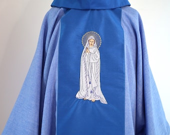 May include: A blue liturgical vestment with an embroidered image of the Virgin Mary on the back. The image is white and features a halo and a rosary.