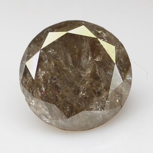 Op de afbeelding: Een ronde, bruine diamant met een facetgeslepen vorm. De diamant heeft een licht troebele uitstraling.