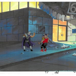 May include: Animation cel featuring two characters in a city setting. One character wears a purple cape and armor, the other a red shirt and black pants. The background includes a building with a number 6 sign.
