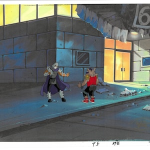 May include: An original animation cel featuring two characters from the Teenage Mutant Ninja Turtles series. One character is Shredder, in a purple cape, and the other is Bebop, in a red shirt. The background shows a city street.