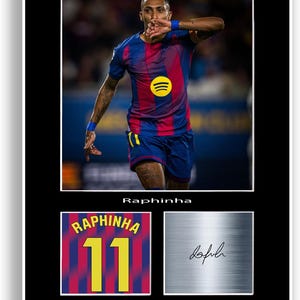 May include: Framed print featuring a soccer player in a blue and red jersey with the Spotify logo. The print includes the player's name, jersey number, and a signature on a metallic background.