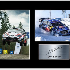 May include: Framed print featuring rally racing action. Includes two action shots of rally cars, one airborne and the other on a snowy track. A third image shows a signature and the name "Ott Tänak".