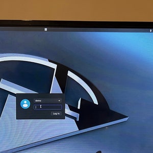 May include: A computer screen displaying a login page with a black background and a gray and white logo. The login page has a text field for username with the word "demo" already entered, a text field for password, and a button that says "Log In".