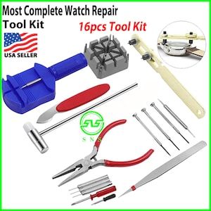 May include: A 16-piece watch repair tool kit with a blue and red watch band tool, a silver hammer, a pair of red-handled pliers, a gold watch band tool, a silver watch band tool, a gray watch band tool holder, and a set of silver tools.