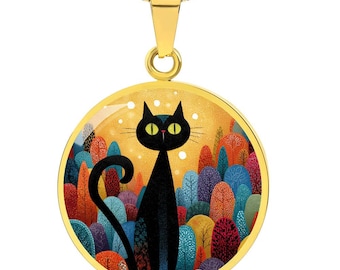 May include: Gold-toned pendant necklace featuring a black cat illustration. The round pendant has a yellow background with colorful trees. The cat has yellow eyes and a long, curved tail. The necklace chain is a gold-colored snake chain.
