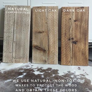 May include: Three wood samples showing different finishes: natural, light oak, and dark oak. The text "We use natural, non-toxic waxes to protect the wood and obtain these colors" is below the samples.