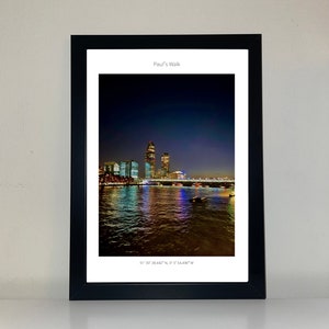 May include: A framed photograph of a cityscape at night with a bridge and a river reflecting the city lights. The caption reads "Paul's Walk" and the coordinates "51°30' 38.440" N, 0° 5' 54.490" W".