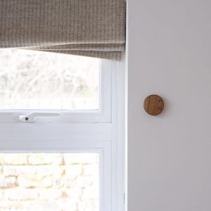 oak wooden key holder next to window