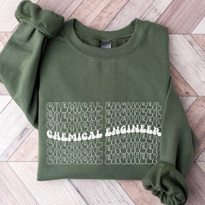 May include: A green sweatshirt with the text "CHEMICAL ENGINEER" repeated in a retro font style.