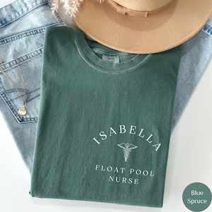 May include: A green t-shirt with the text "Isabella Float Pool Nurse" and a caduceus symbol.