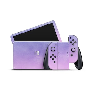 May include: A purple and pink ombre Nintendo Switch console and matching Joy-Con controllers. The console has a textured, watercolor-like design.