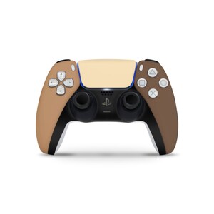 May include: A beige and brown PlayStation 5 DualSense wireless controller with black buttons and a blue PlayStation logo.