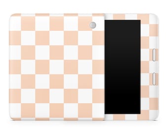 May include: A white tablet with a peach checkered pattern on the back and front. The tablet has a black screen.