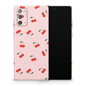 May include: A pink phone case with a pattern of red cherries. The case is designed for a Samsung Galaxy S22 Ultra.