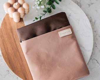 May include: A brown and beige fabric pouch with a white leather label that says "STICKIETECH".