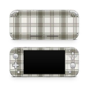 May include: A white and green plaid Nintendo Switch Lite console. The console has a white screen and black buttons. The back of the console is also covered in the plaid pattern.