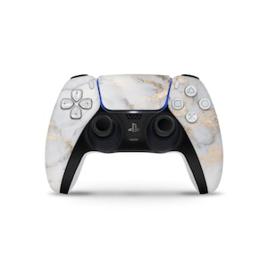 May include: A white and gold marble patterned PlayStation 5 DualSense wireless controller.