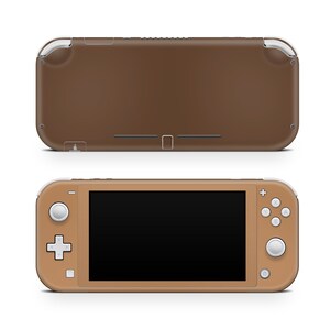 May include: A brown Nintendo Switch Lite handheld gaming console with a black screen. The console has white buttons and a white joystick.