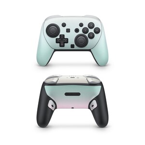 May include: A mint green and white Nintendo Switch Pro Controller. The controller has black buttons and joysticks. The bottom of the controller is black with a gradient of mint green and pink. The word "Nintendo" is printed on the bottom.