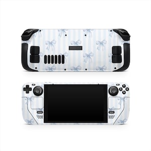 May include: A Steam Deck gaming console with a custom skin featuring a pattern of light blue bows on a white and light blue striped background. The console has black control buttons and a black screen.